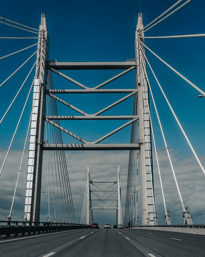 A stunning cable-stayed bridge with modern architecture under a bright blue sky. Perfect for travel or architectural themes.